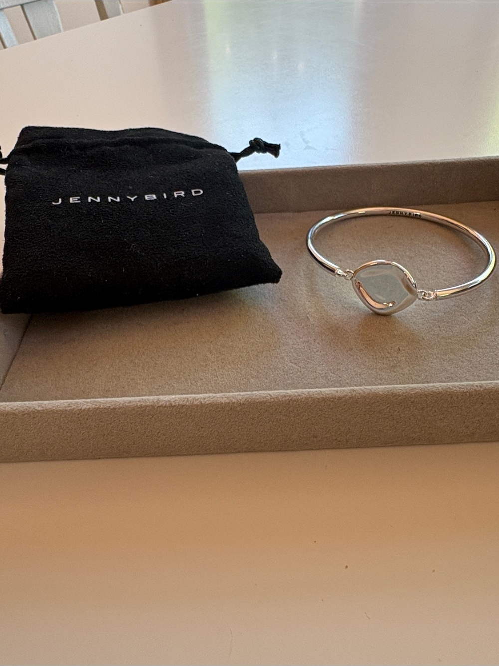 Jenny Bird Silver Bangle with silver flat petal center